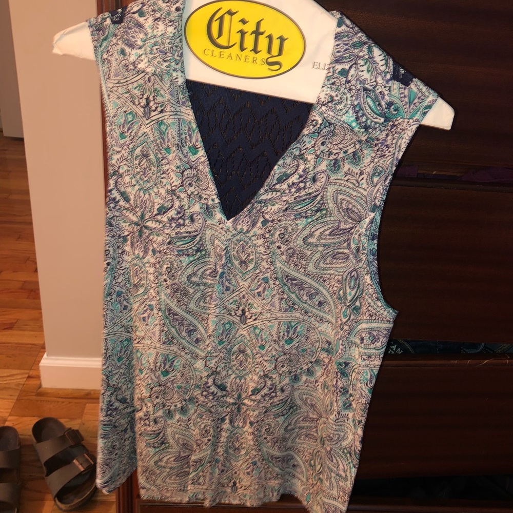 A blue colored shirt with a lace see through back